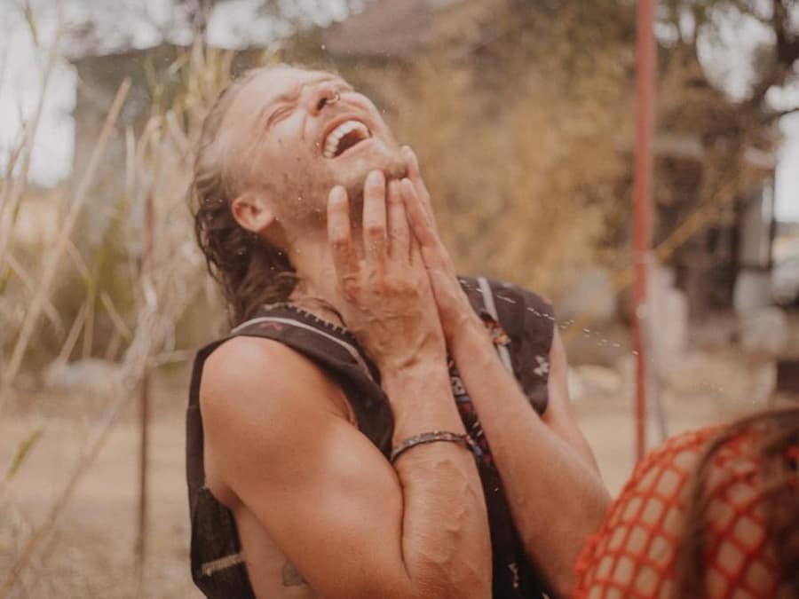 Mycelliohm laughing with his head tilted back and his hands at his chin