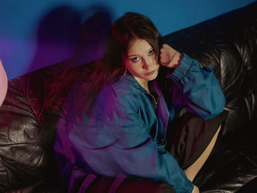 anette lounging on a leather sofa