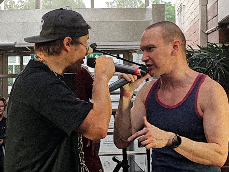 Two Notkea Rotta rappers facing each other with microphones