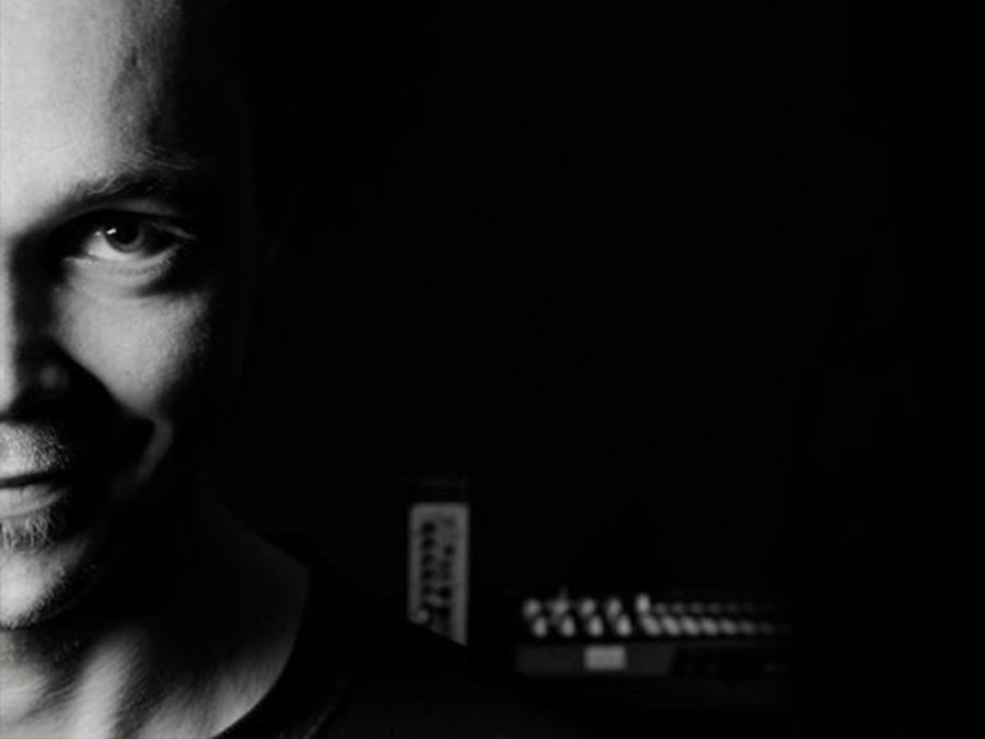 Black-and-white close-up of Agenth’s half-lit face