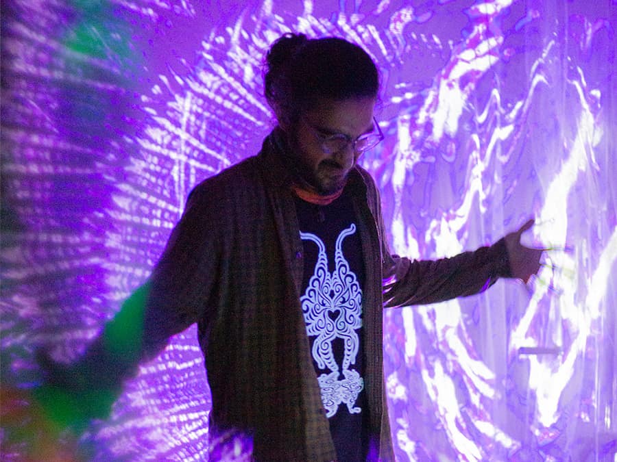 Imaginary Rabbit standing in swirling purple projected light