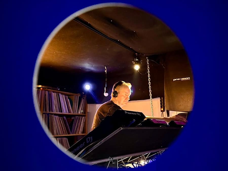 Terva at the decks, framed through a round window