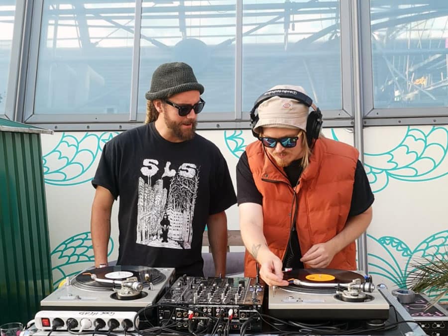 The two suomisettii DJs playing records on a pair of turntables