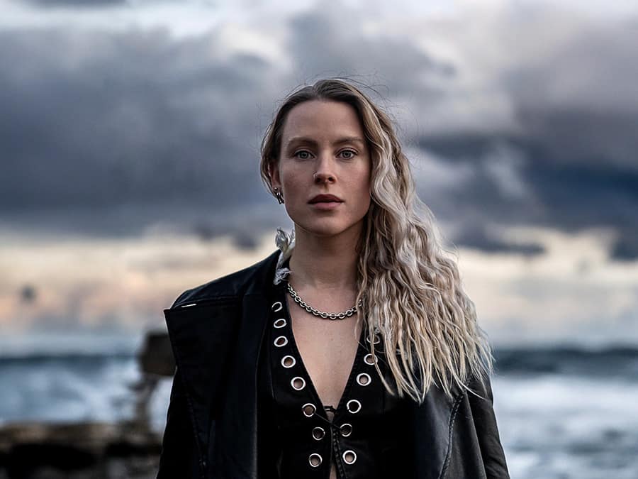 Saija standing on a stormy seashore