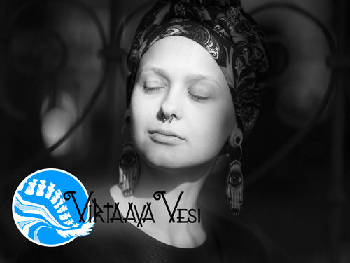 Black-and-white portrait of Sasja with eyes closed, wearing a patterned headscarf and large earrings, beside the Virtaava Vesi logo