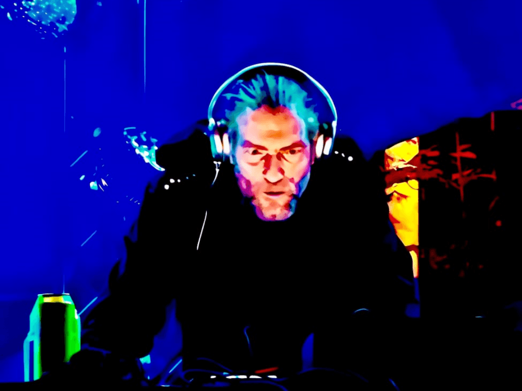 Squaremeat in headphones at the controls, in a colour-inverted photo