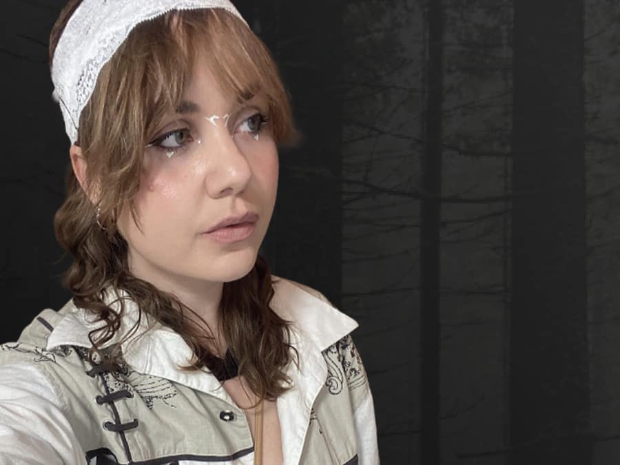 Portrait of EMI in a white headscarf and glasses