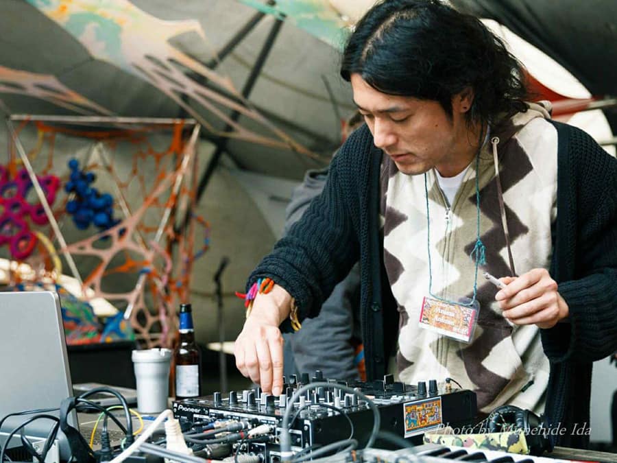 AniMa AniMus adjusting a mixer at an outdoor stage