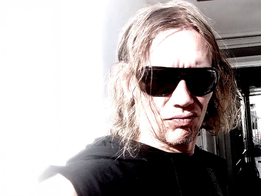 A long-haired member of Antiscarp Warriors in dark sunglasses