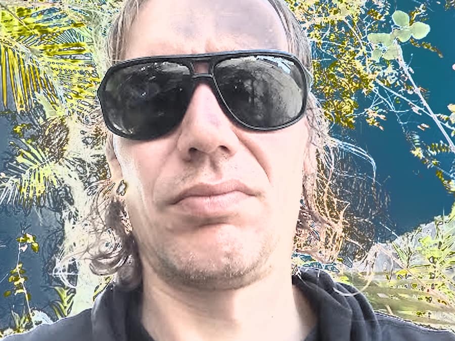 Dj Whiskey Baba in large dark sunglasses, in a close-up selfie outdoors