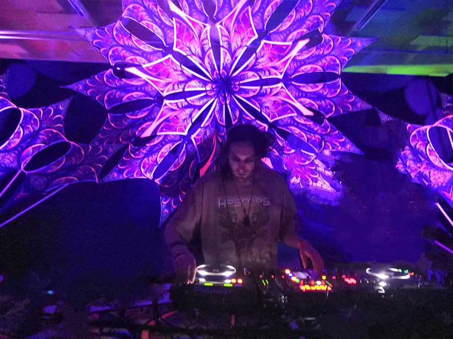 Aazuuh at the decks under a UV kaleidoscope canopy
