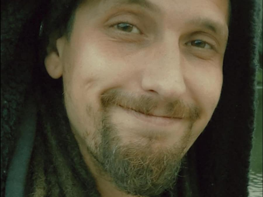 Close-up of a smiling, bearded Kaius Bactus