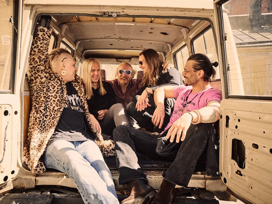 The members of Gardenhead sitting in the back of a van