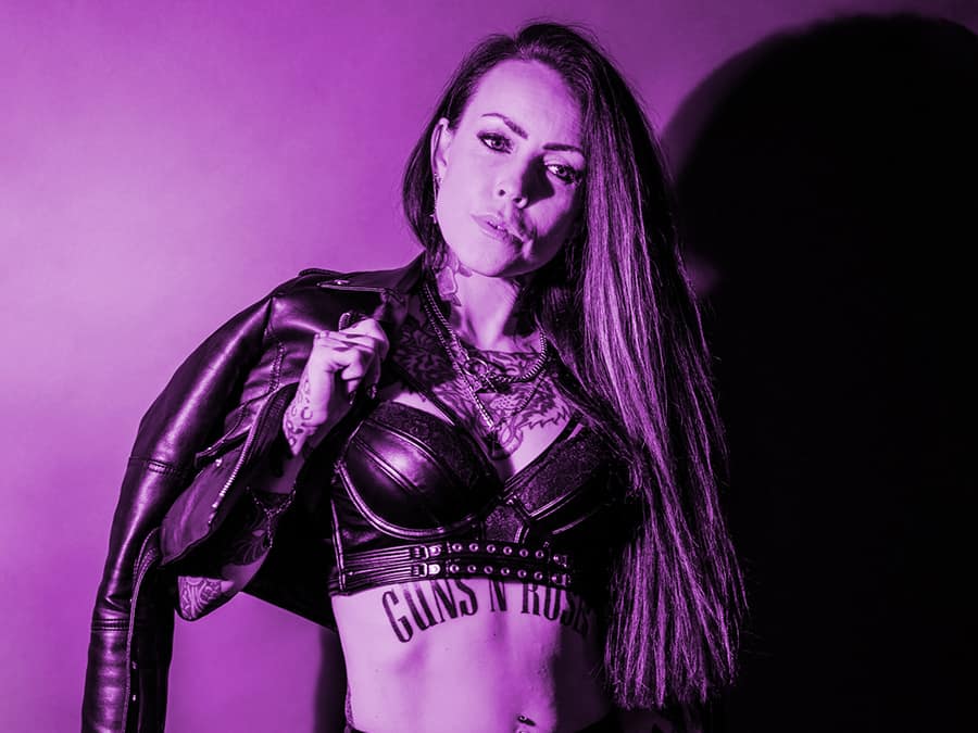 Milla Lehto in a leather jacket, photographed in purple tones