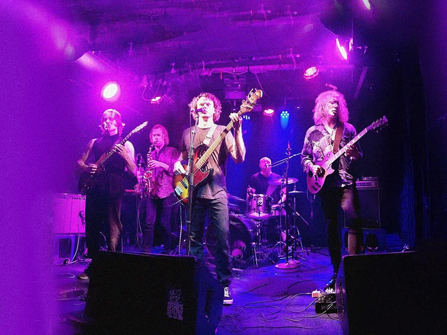 Dai Kaht playing live on a purple-lit stage
