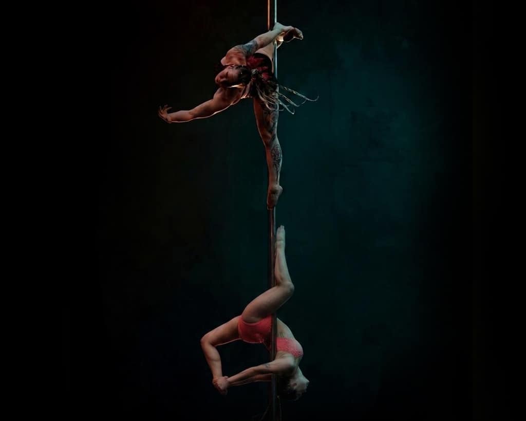 Satu and Chrisu performing together on a single dance pole